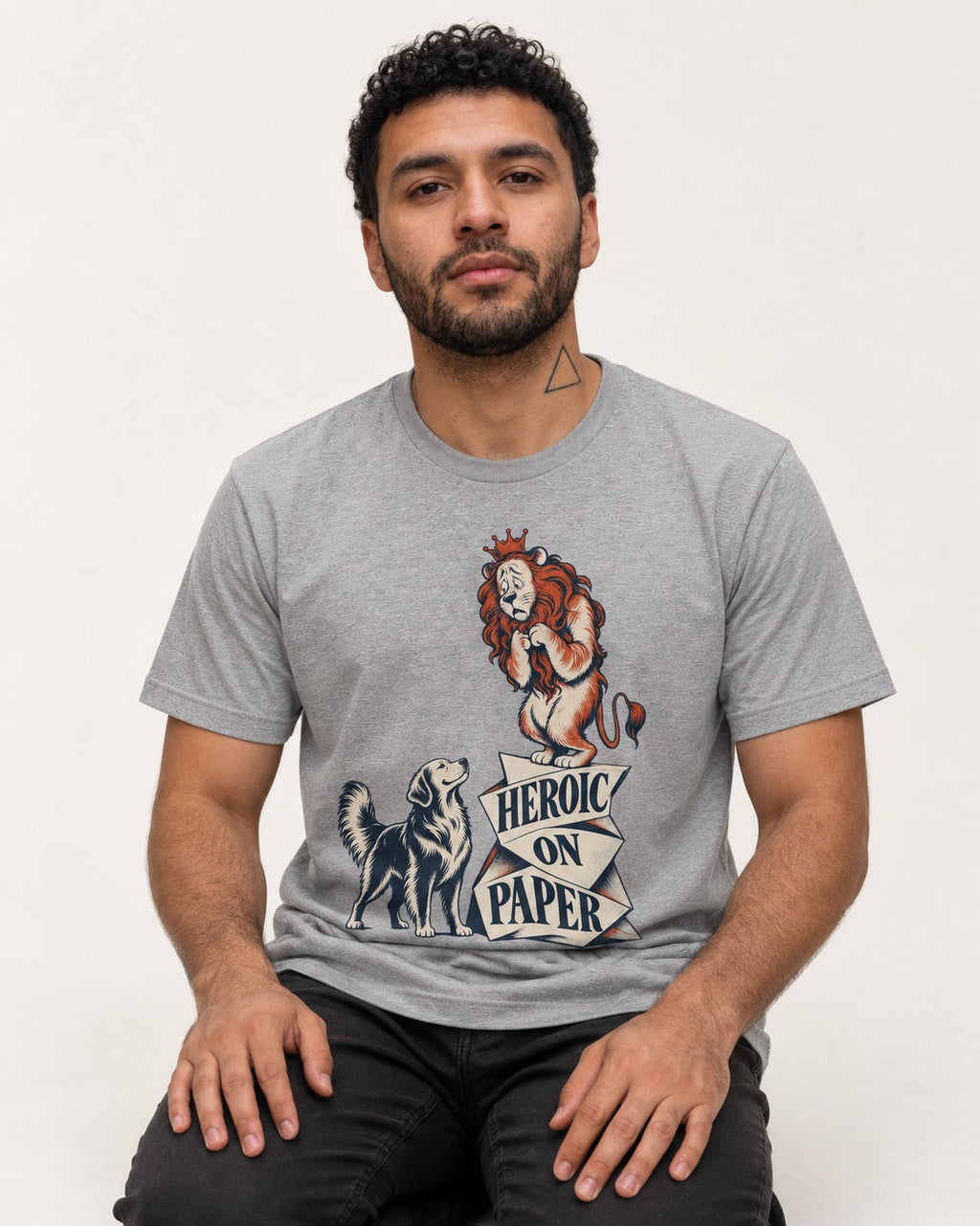 Golden Retriever Heroic on Paper Lion Graphic T-Shirt in Sport Grey, worn by a seated model