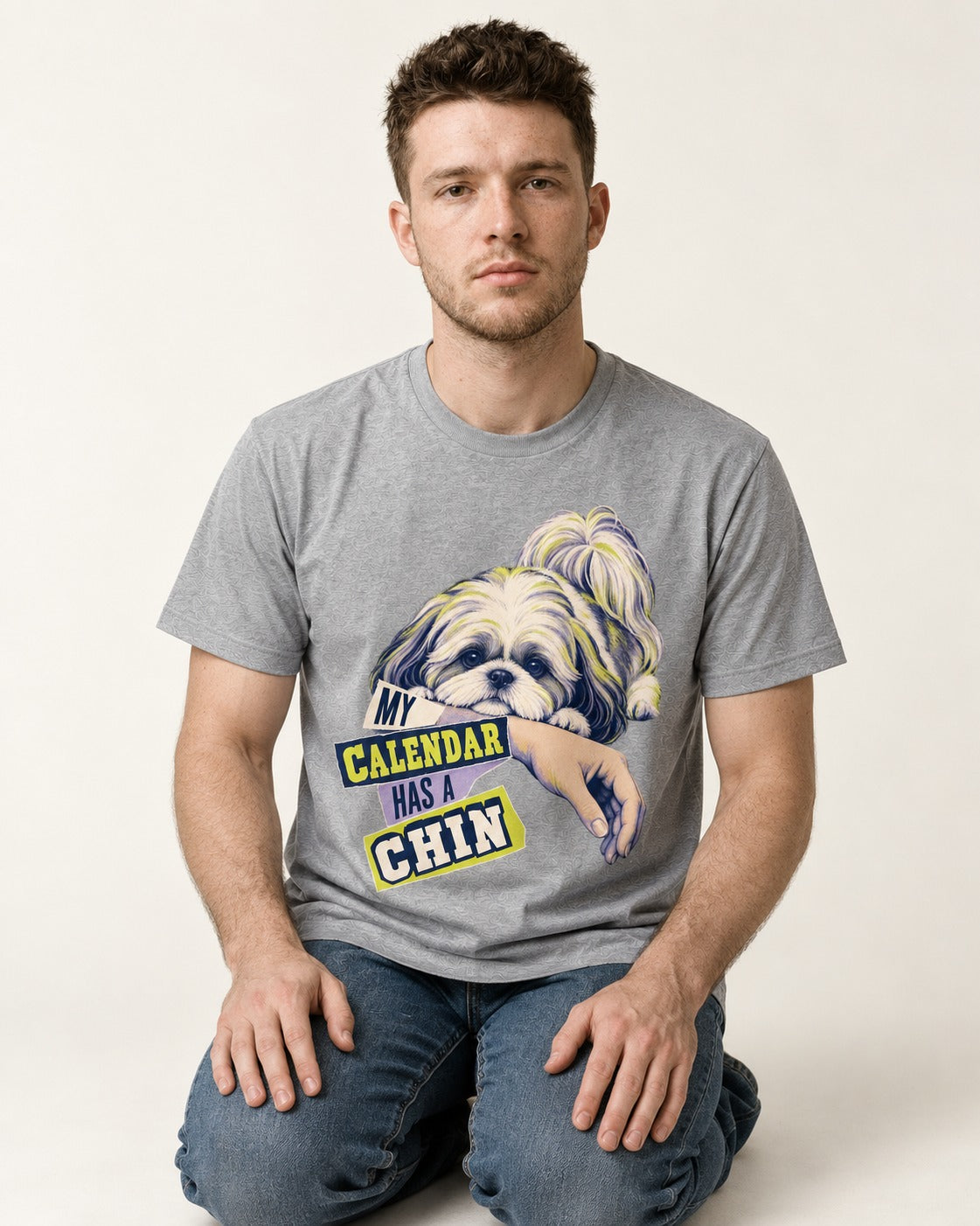 Shih Tzu My Calendar Has a Chin Arm Rest Graphic T-Shirt in Sport Grey, worn by a seated model