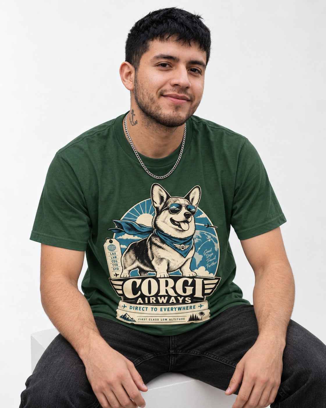 Corgi Airways Direct to Everywhere Badge T-Shirt in Forest Green, worn by a seated model