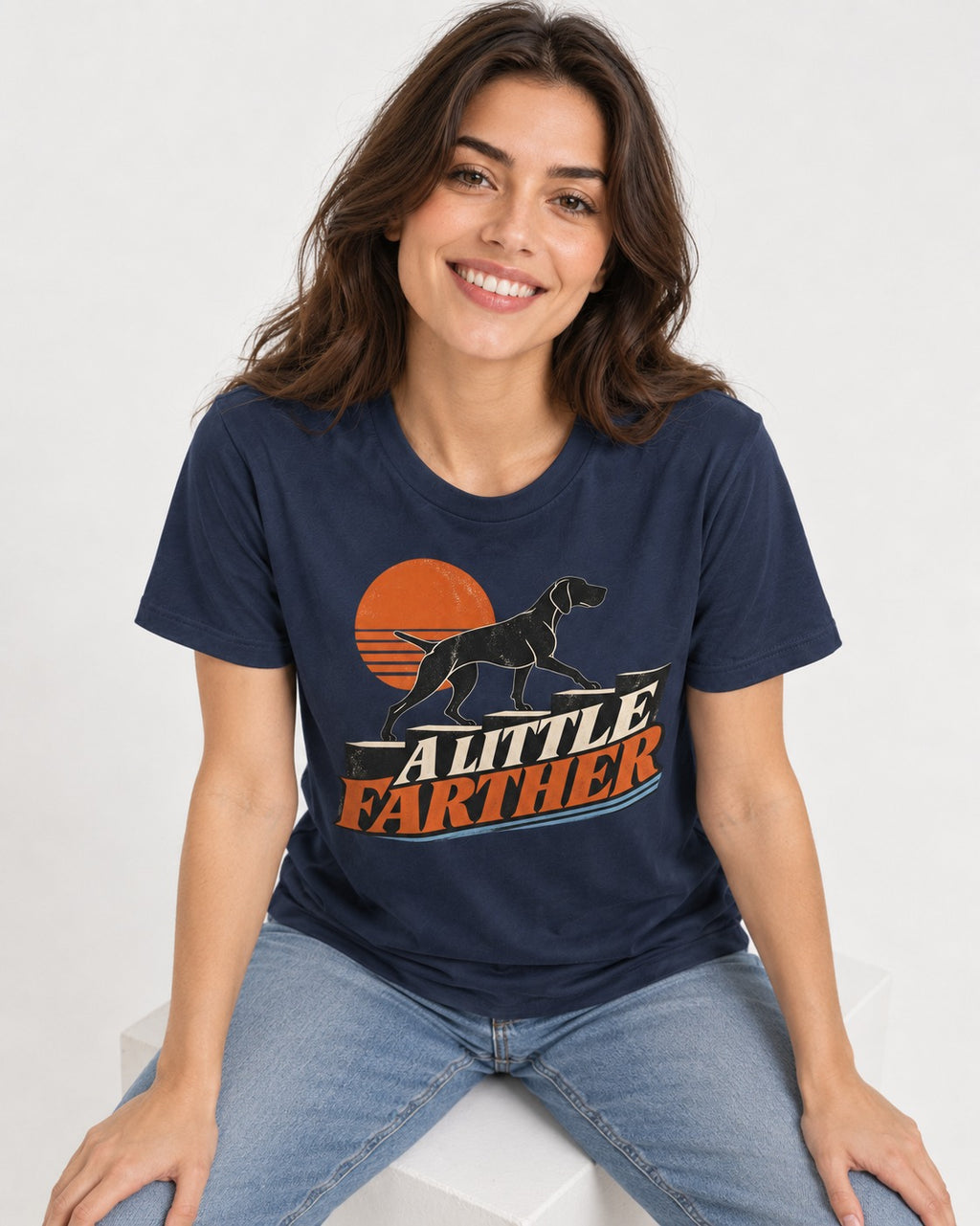 German Shorthaired Pointer A Little Farther Sunset Steps Graphic T-Shirt in Navy, worn by a seated model