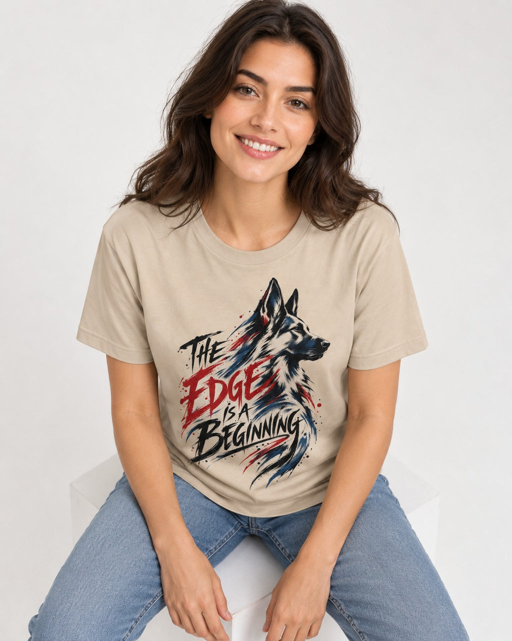 Edge Is a Beginning German Shepherd Dog T-Shirt in Sand, worn by a seated model
