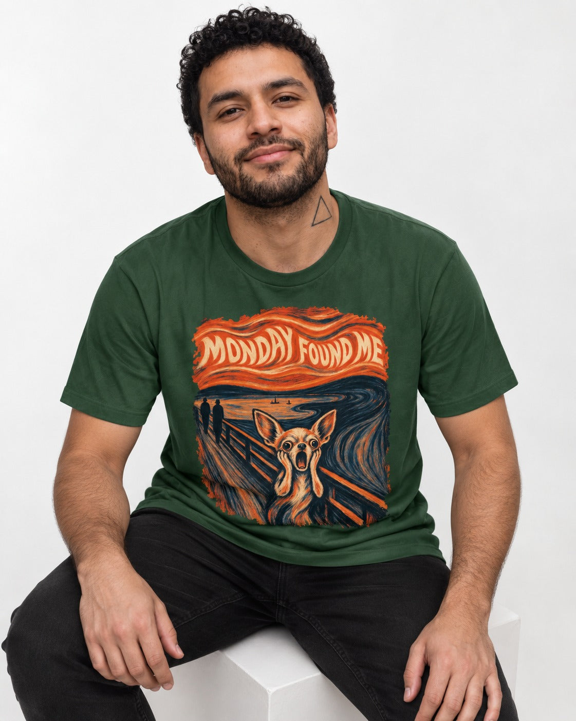 Monday Found Me Chihuahua Scream Banner T-Shirt in Forest Green, worn by a seated model
