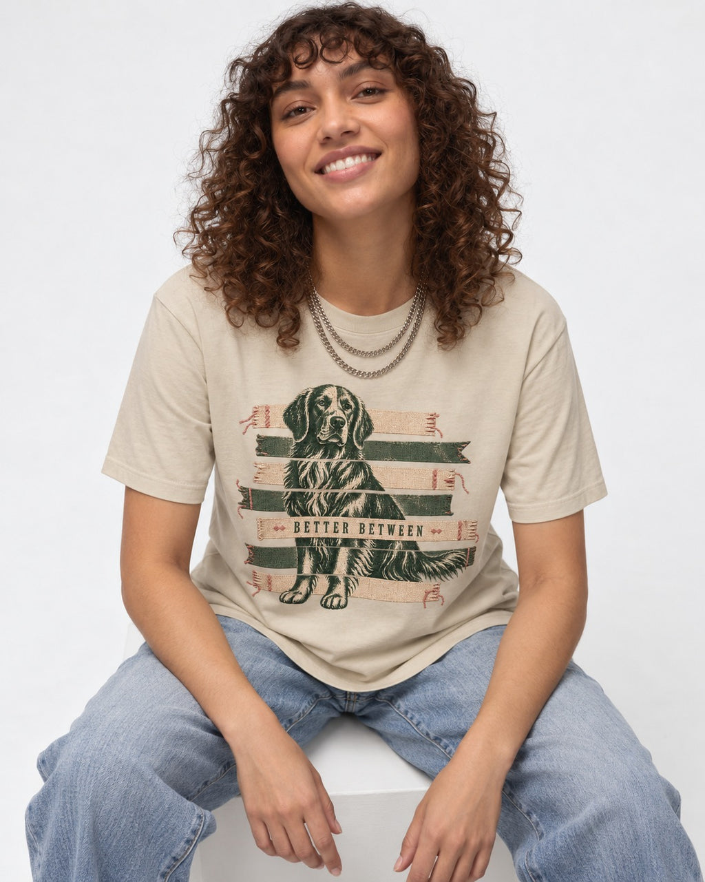 Golden Retriever Better Between T-Shirt in Sand, worn by a seated model