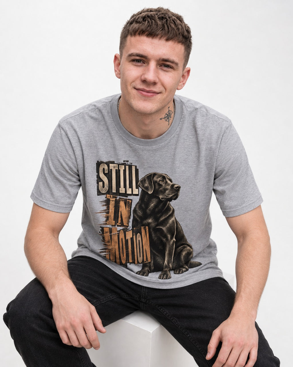 Labrador Retriever Still in Motion Seated Graphic T-Shirt in Sport Grey, worn by a seated model