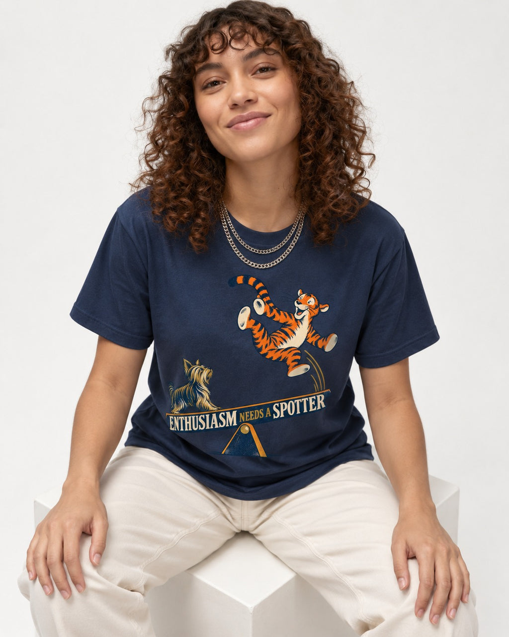 Yorkshire Terrier Enthusiasm Needs a Spotter Seesaw Graphic T-Shirt in Navy, worn by a seated model