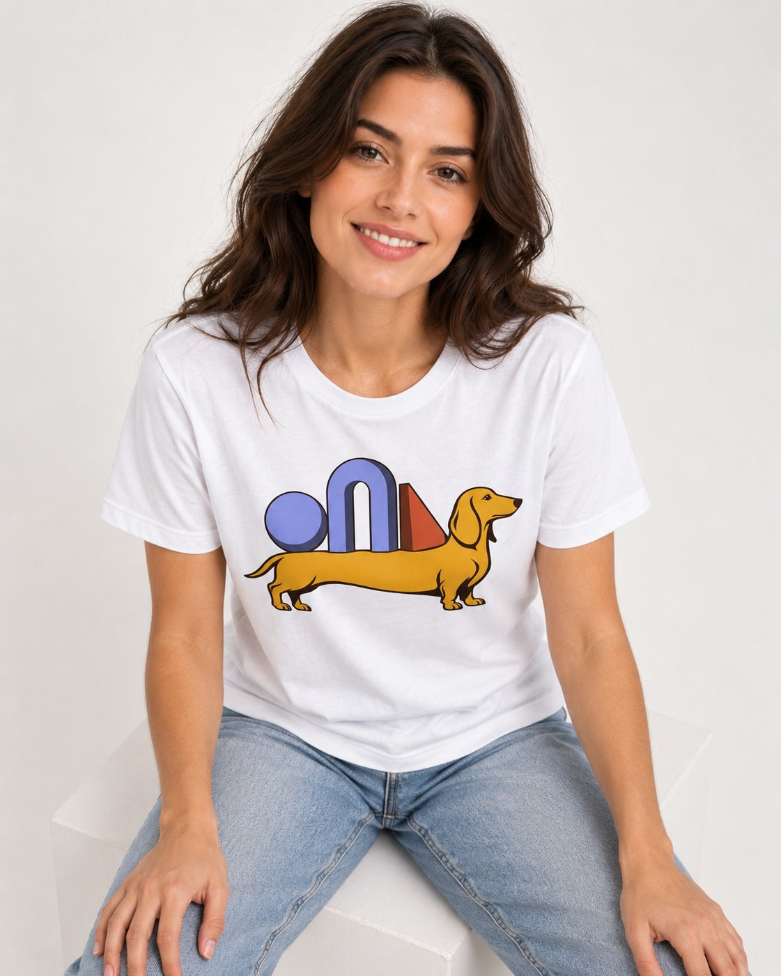 Dachshund Daydream T-Shirt in White, worn by a seated model