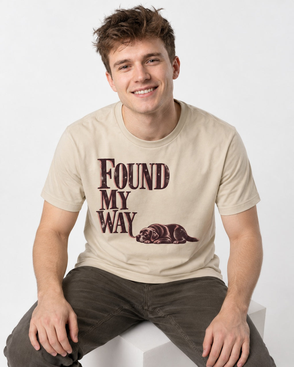 Found My Way Labrador Retriever T-Shirt in Sand, worn by a seated model