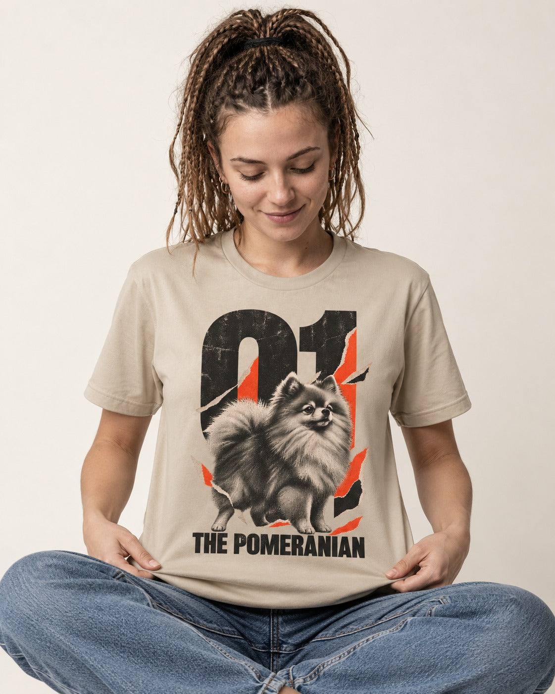 The Pomeranian T-Shirt in Sand, worn by a seated model