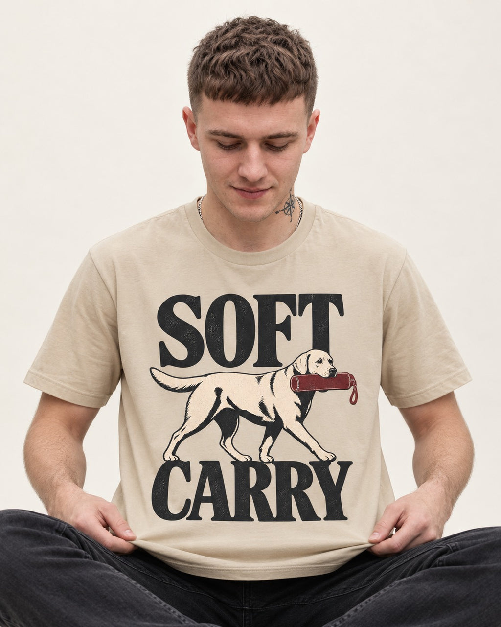 Soft Carry Labrador Retriever T-Shirt in Sand, worn by a seated model
