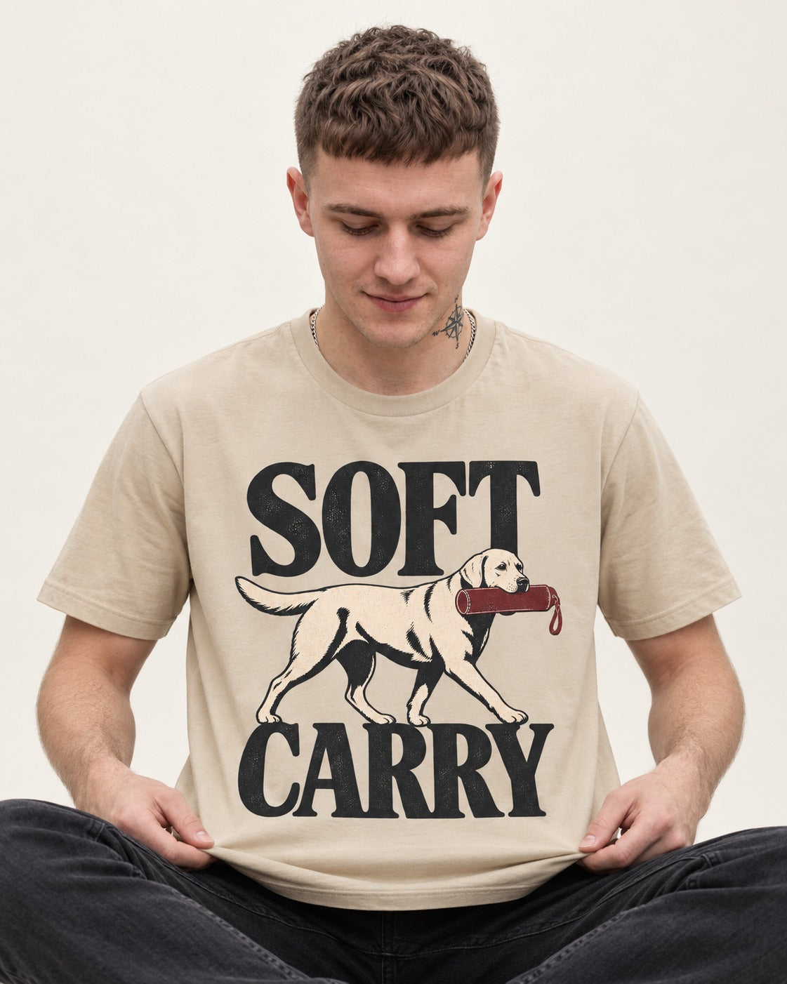 Soft Carry Labrador Retriever T-Shirt in Sand, worn by a seated model
