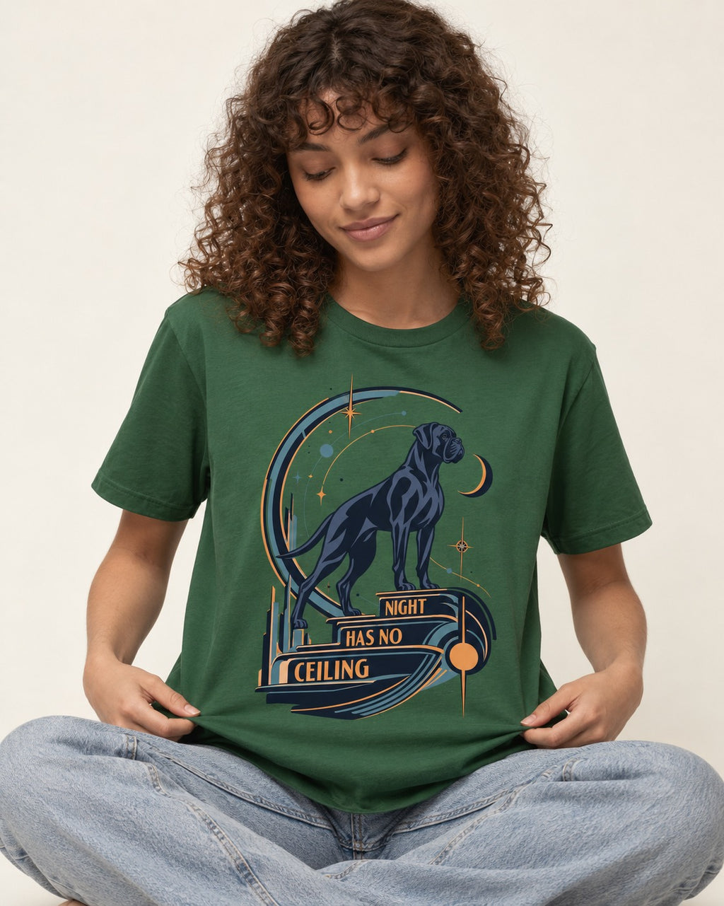 Night Has No Ceiling Boxer Cosmic Graphic T-Shirt in Forest Green, worn by a seated model