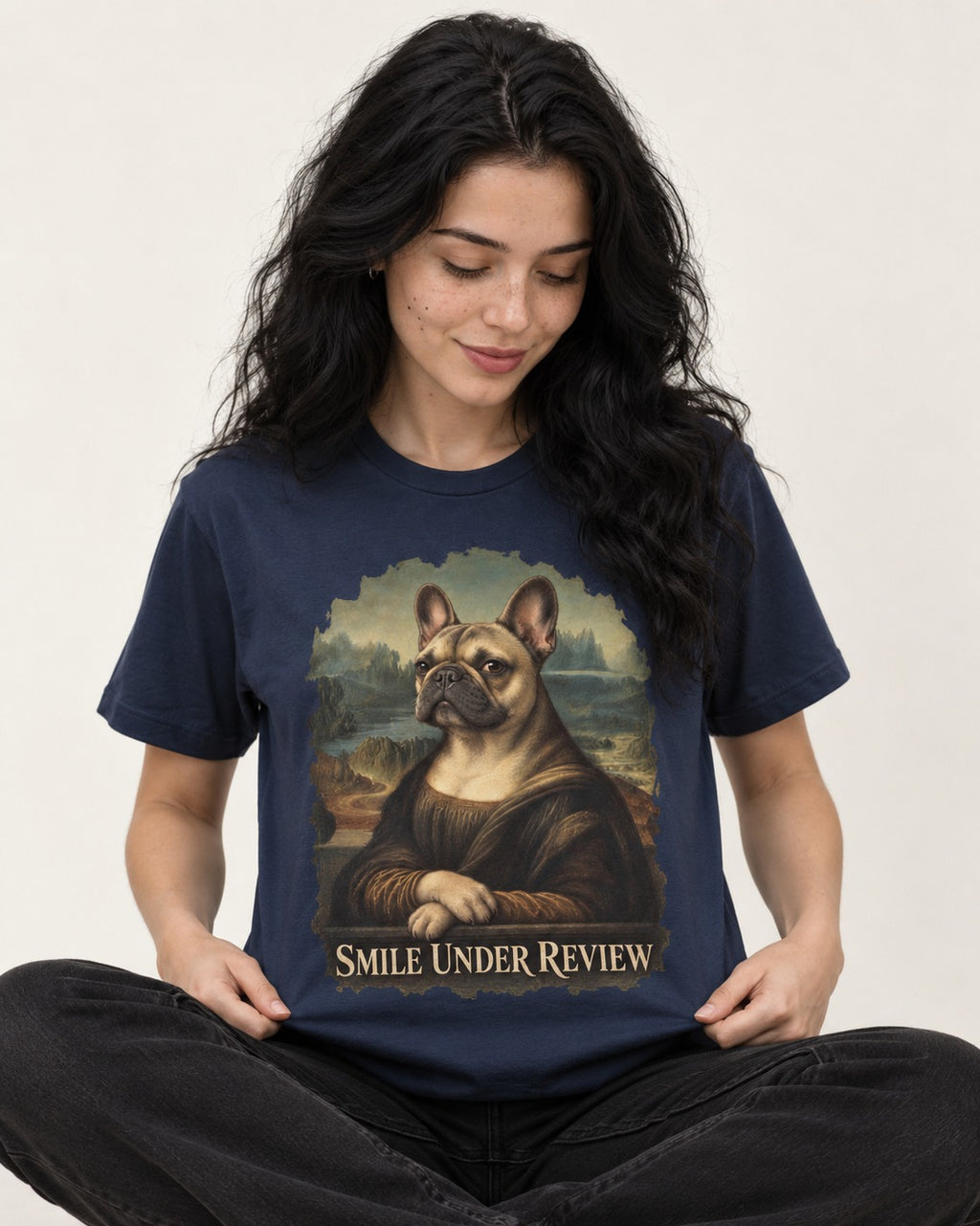 Frenchie Smile Under Review Renaissance Portrait T-Shirt in Navy, worn by a seated model