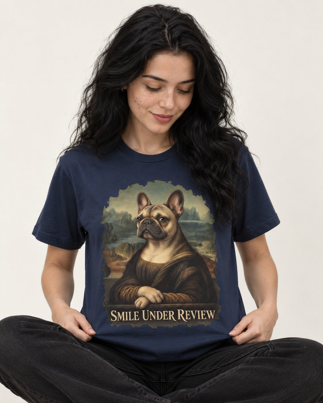 Frenchie Smile Under Review Renaissance Portrait T-Shirt in Navy, worn by a seated model