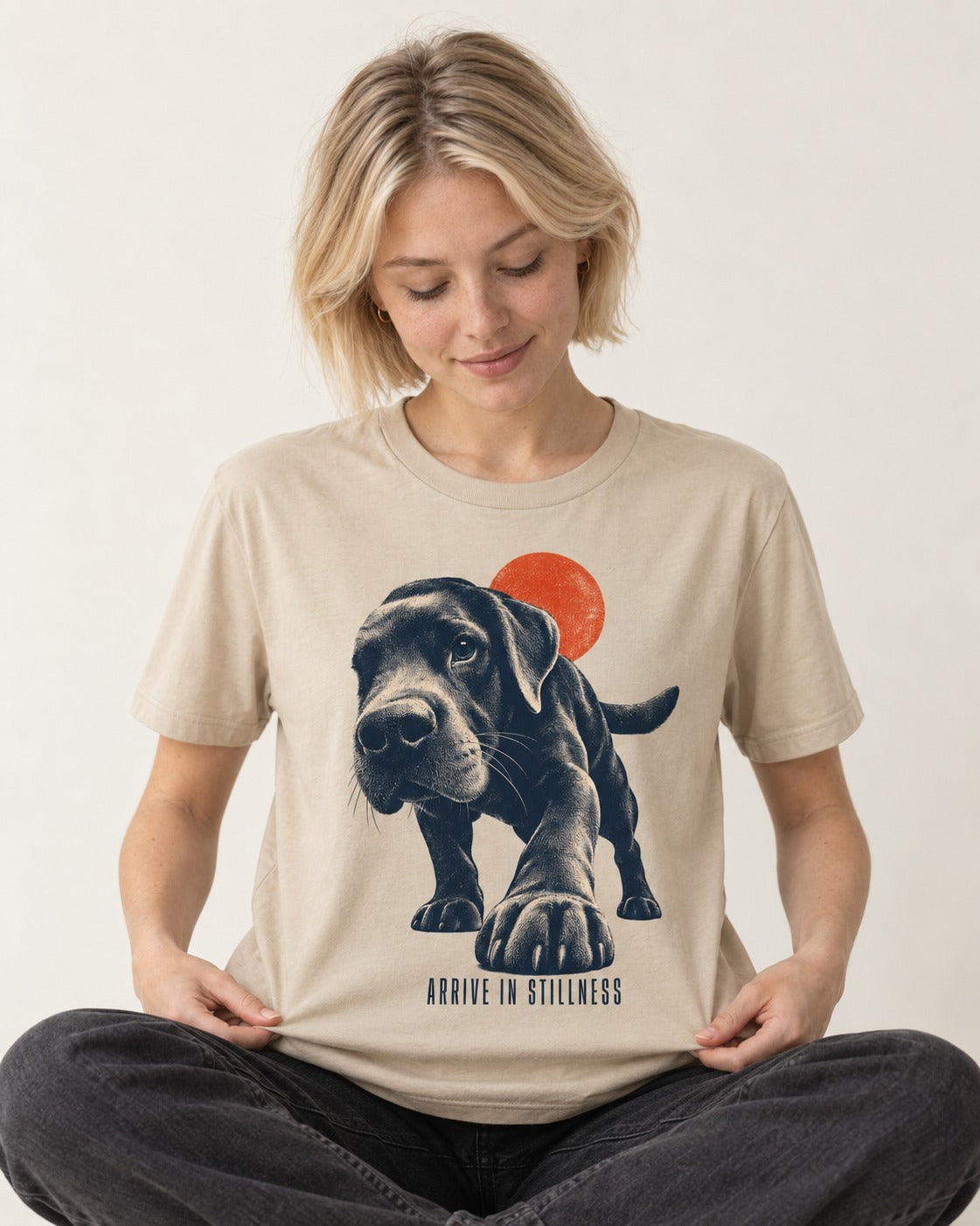 Labrador Retriever Arrive in Stillness T-Shirt in Sand, worn by a seated model