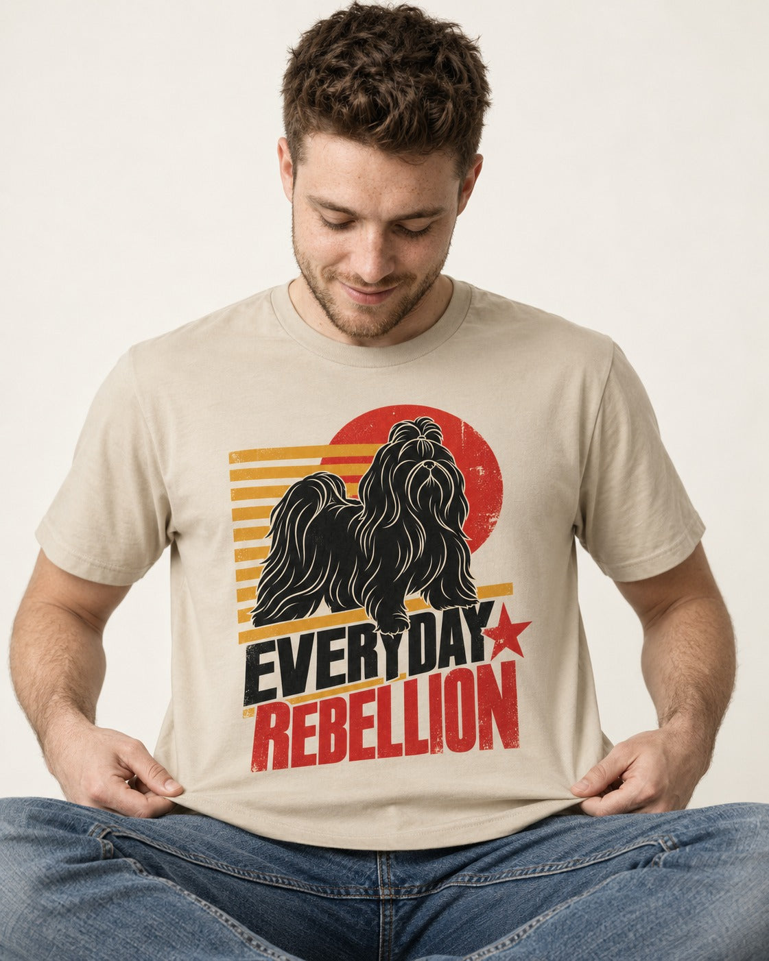 Everyday Rebellion Shih Tzu T-Shirt in Sand, worn by a seated model