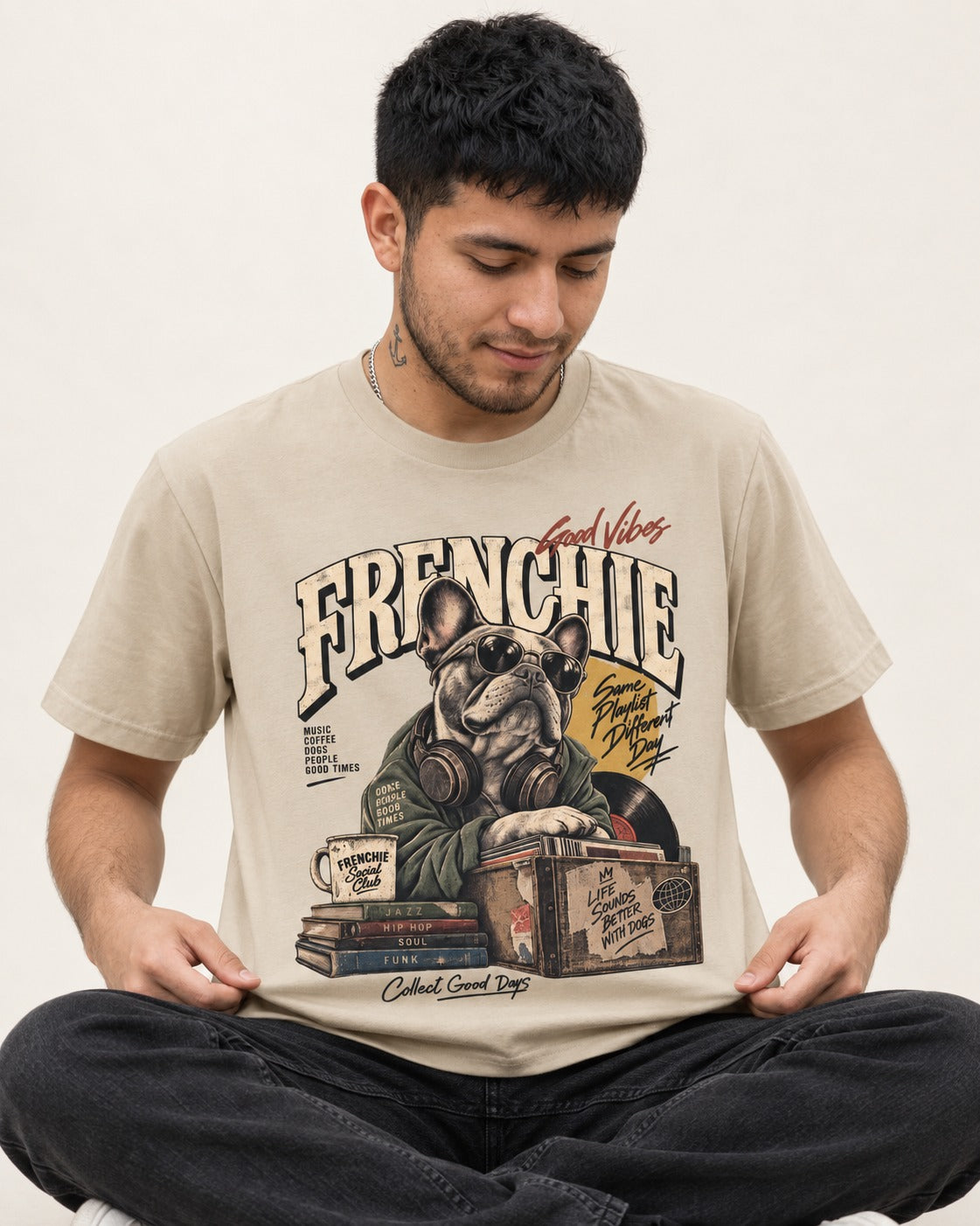 Frenchie Social Club T-Shirt in Sand, worn by a seated model