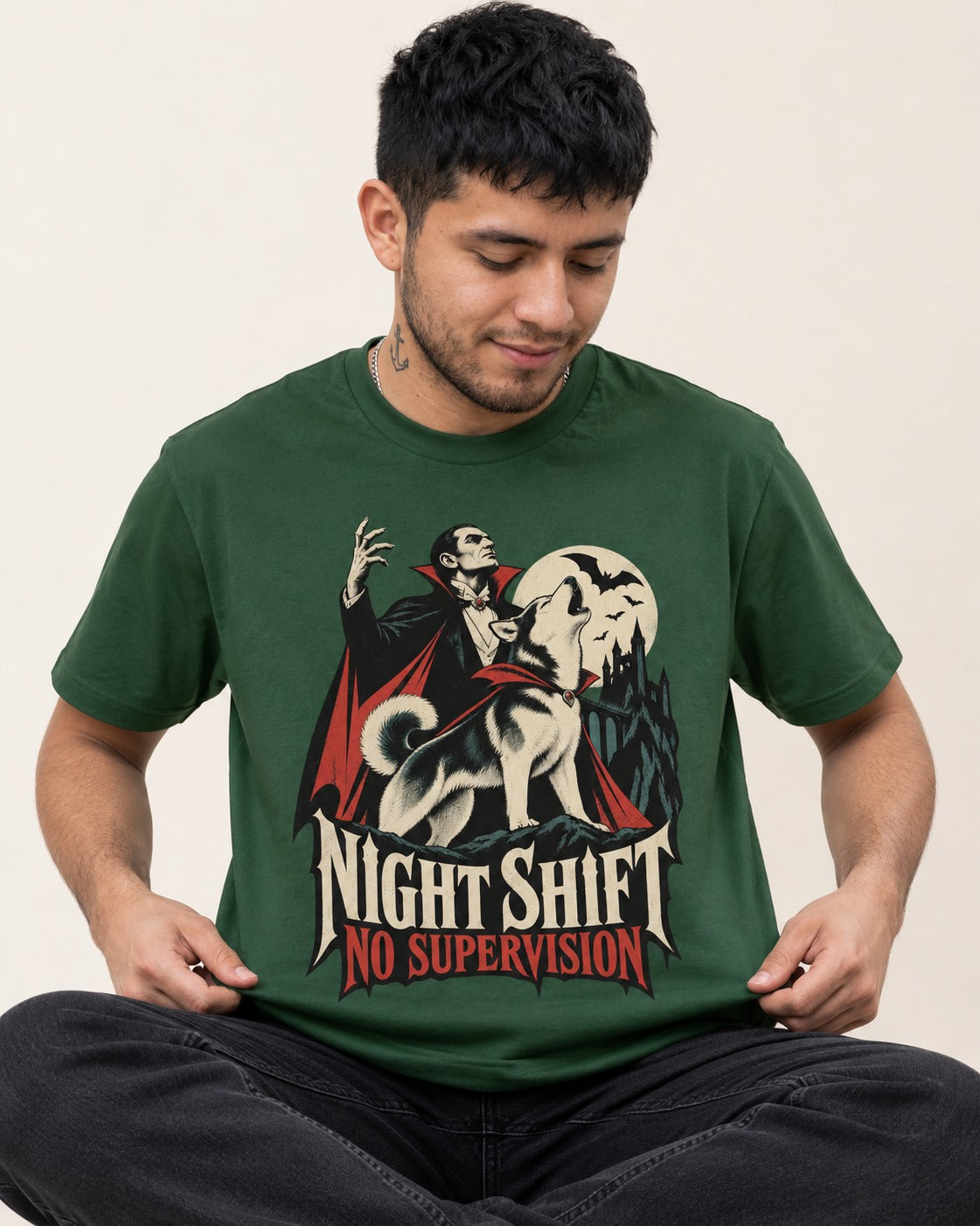Husky Night Shift No Supervision Vampire Graphic T-Shirt in Forest Green, worn by a seated model