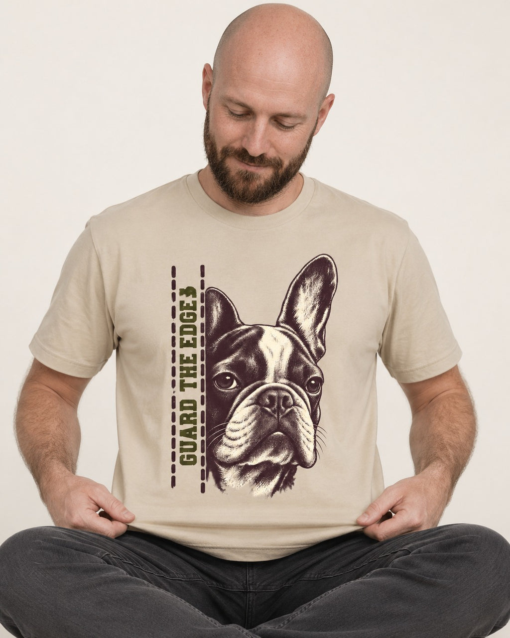 Frenchie Guard the Edge T-Shirt in Sand, worn by a seated model