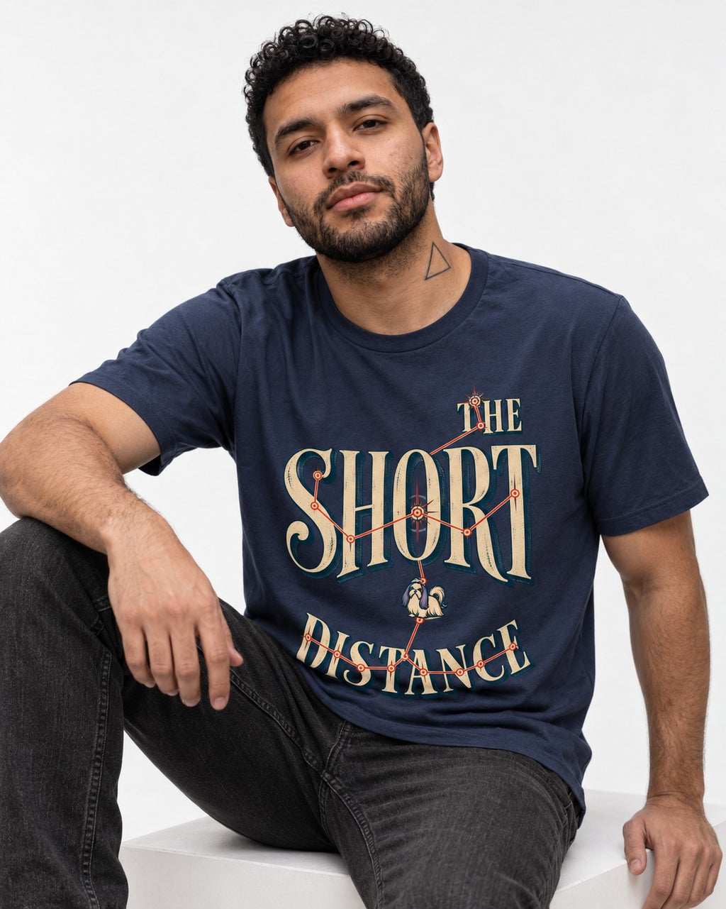 Shih Tzu The Short Distance Route Graphic T-Shirt in Navy, worn by a seated model