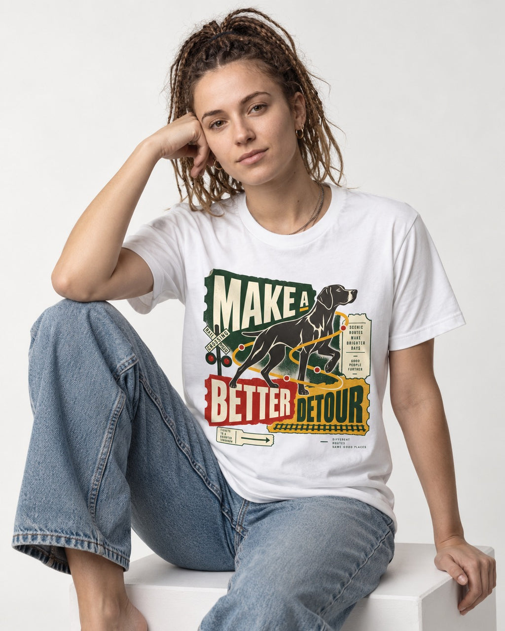 German Shorthaired Pointer Make a Better Detour Railroad Graphic T-Shirt in White, worn by a seated model
