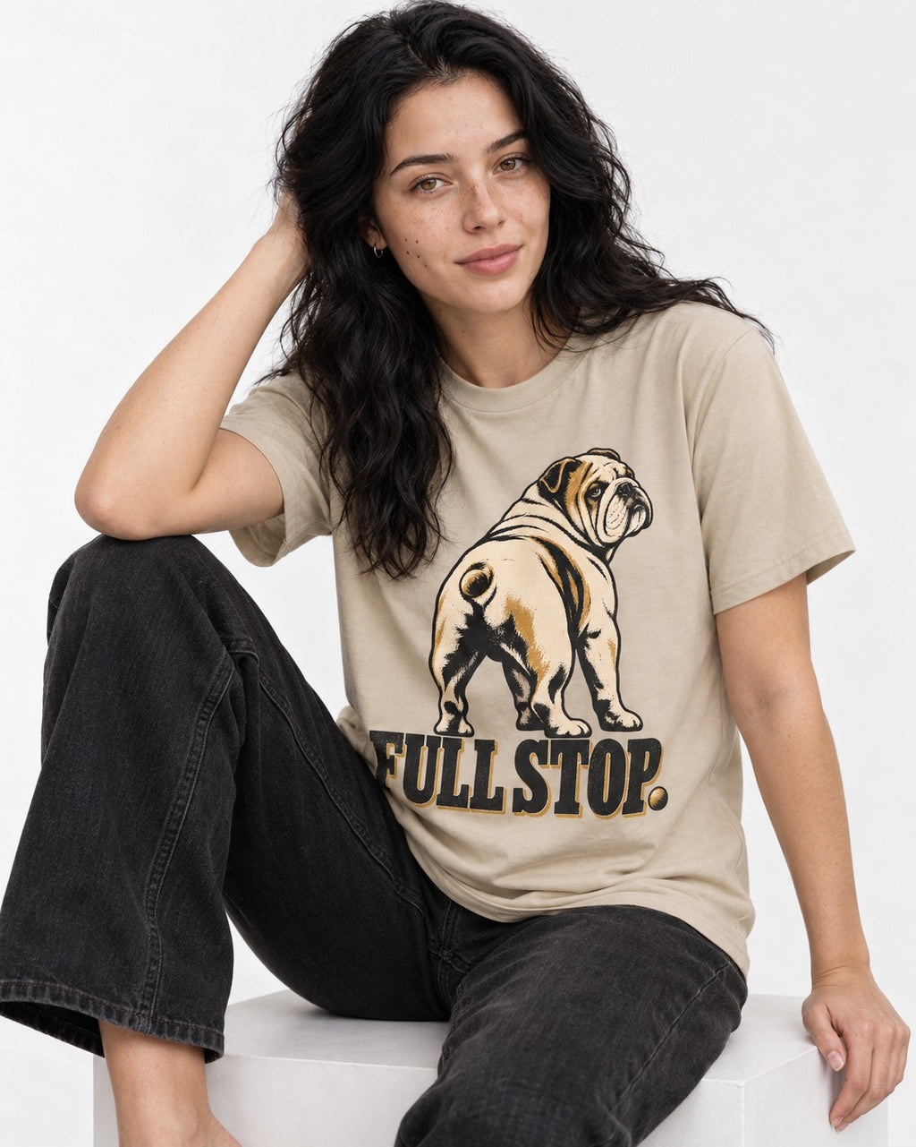 English Bulldog Full Stop T-Shirt in Sand, worn by a seated model