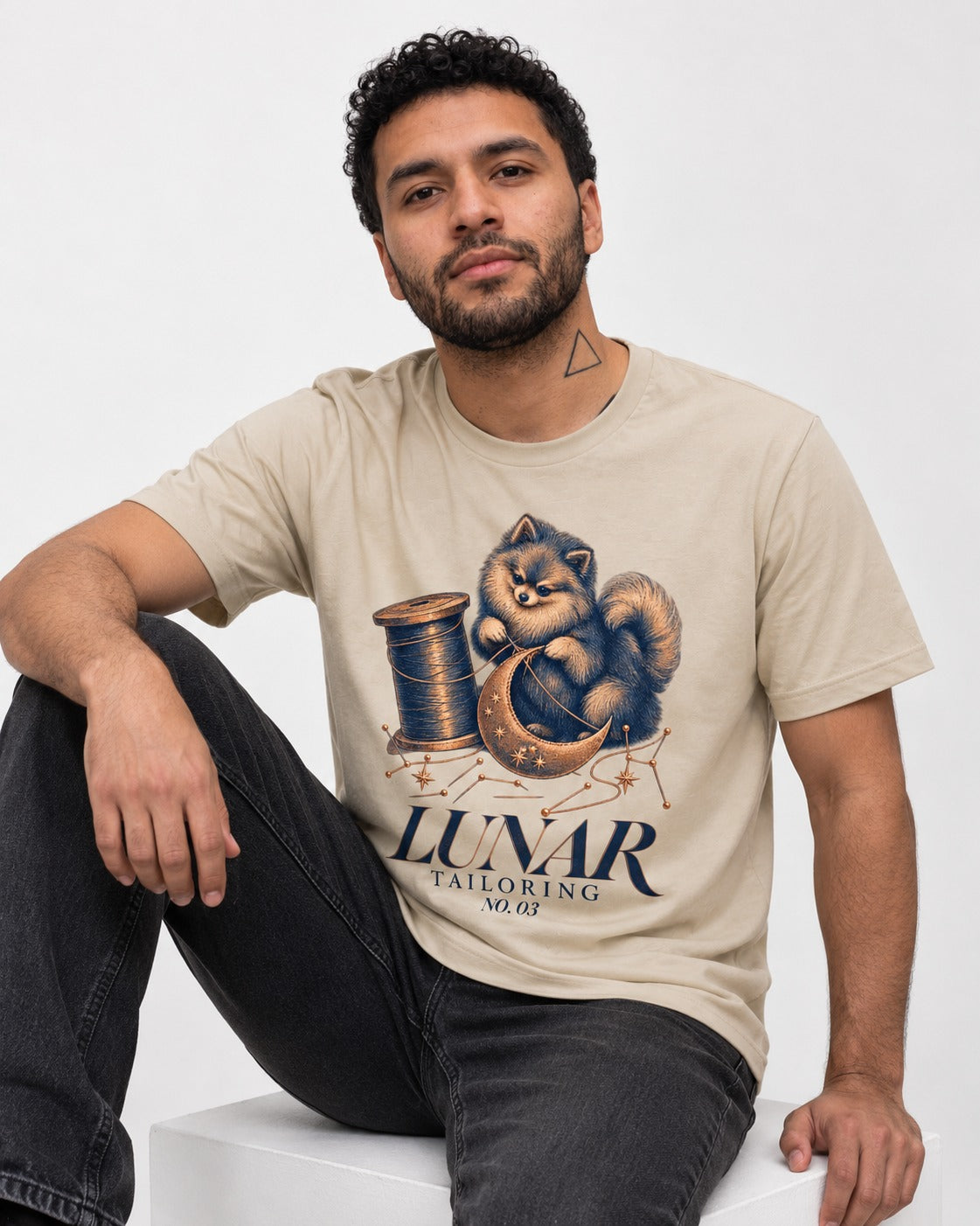 Pomeranian's Lunar Tailoring T-Shirt in Sand, worn by a seated model