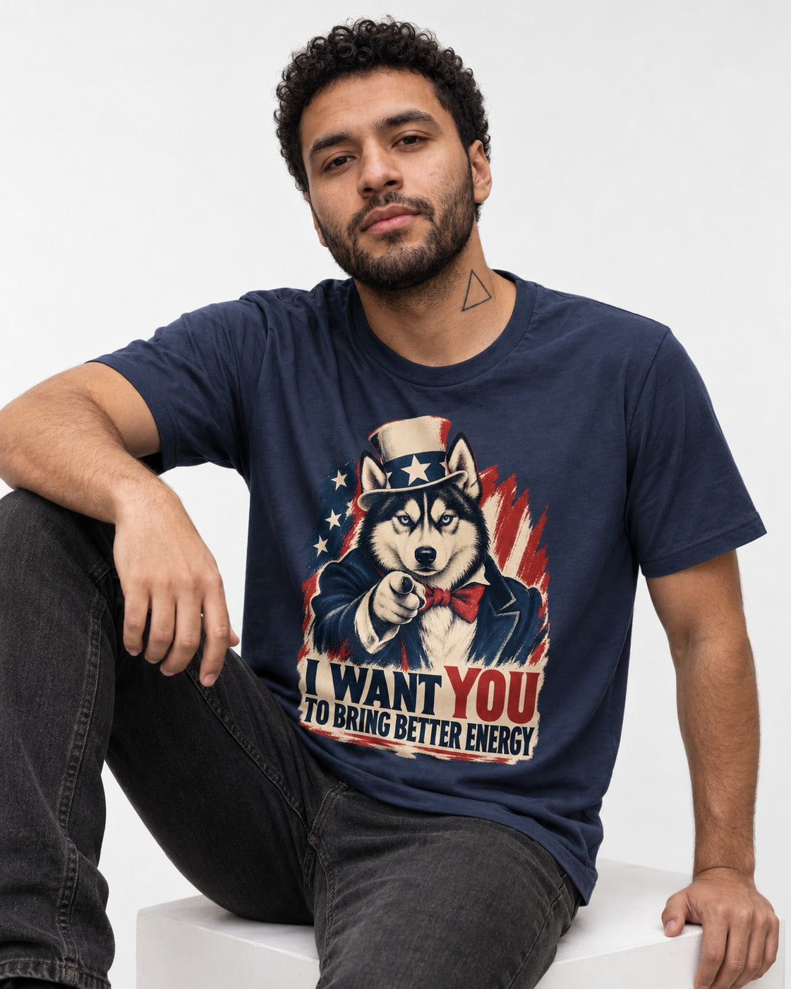 Husky I Want You to Bring Better Energy Patriotic Poster Graphic T-Shirt in Navy, worn by a seated model