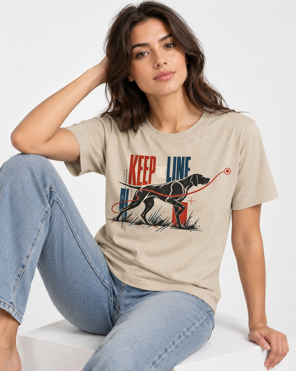 Keep the Line German Shorthaired Pointer T-Shirt in Sand, worn by a seated model