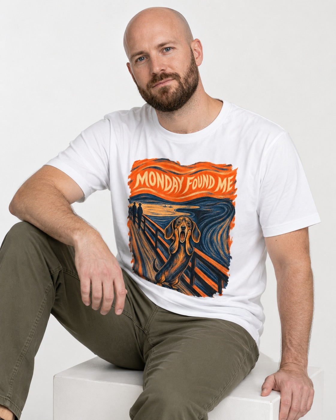 Dachshund Monday Found Me Scream Poster T-Shirt in White, worn by a seated model