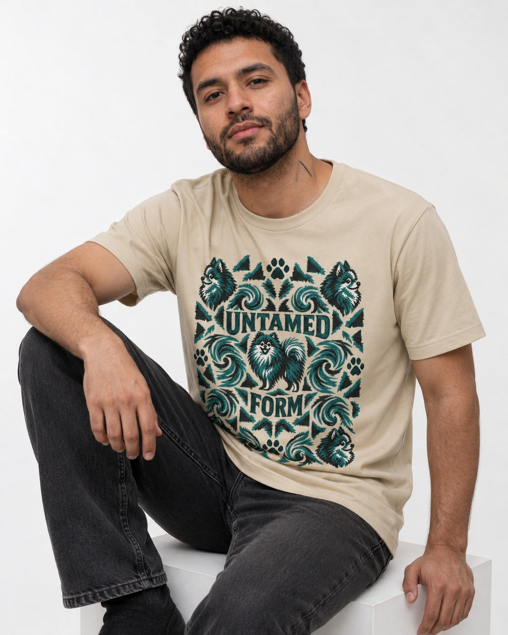 Pomeranian Untamed Form T-Shirt in Sand, worn by a seated model