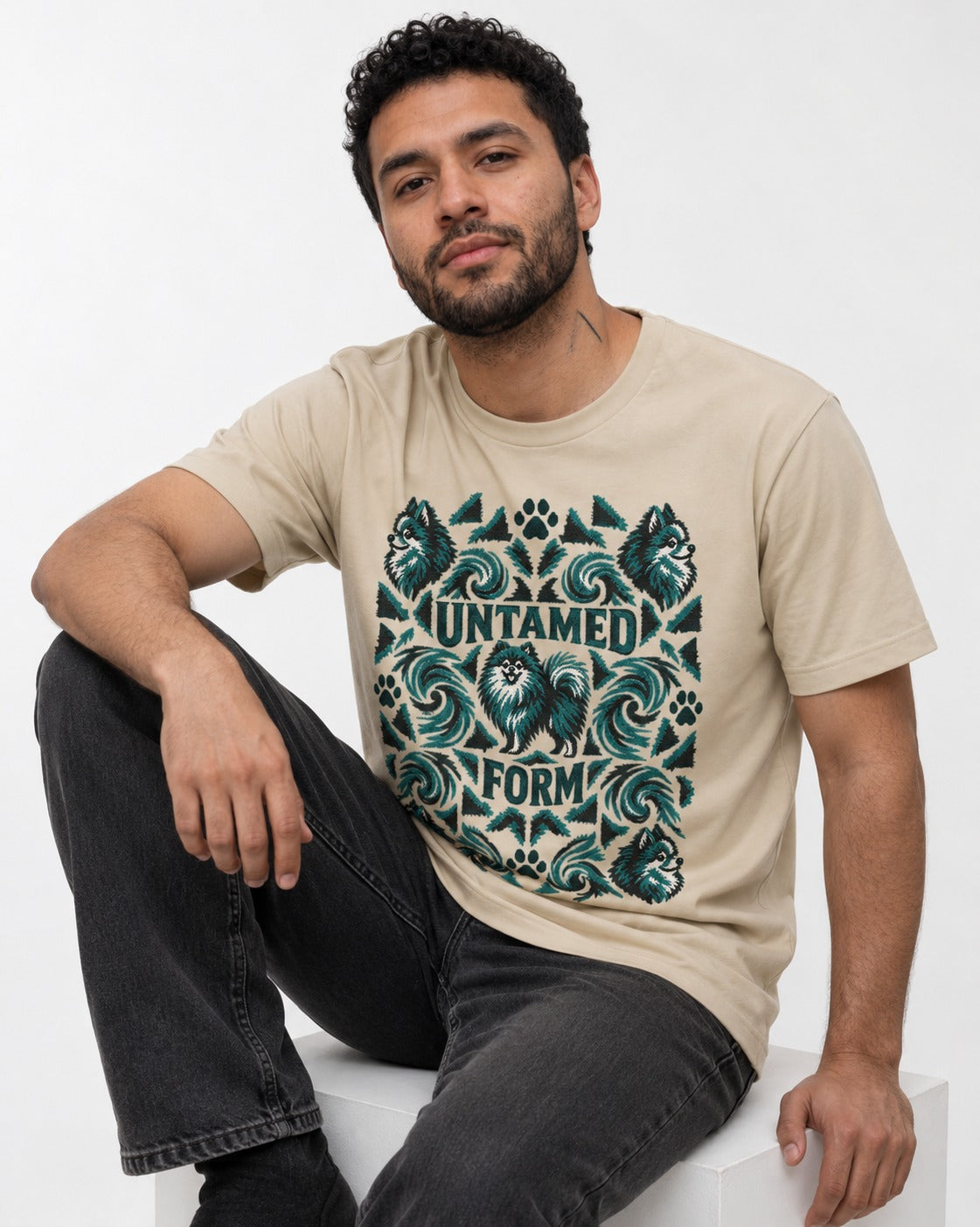 Pomeranian Untamed Form T-Shirt in Sand, worn by a seated model