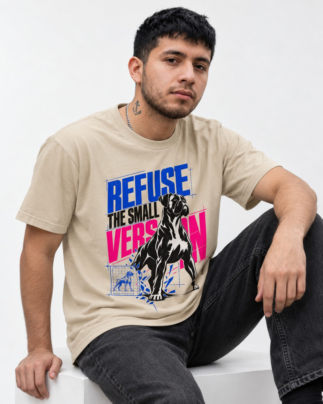 Boxer Refuse the Small Version T-Shirt in Sand, worn by a seated model