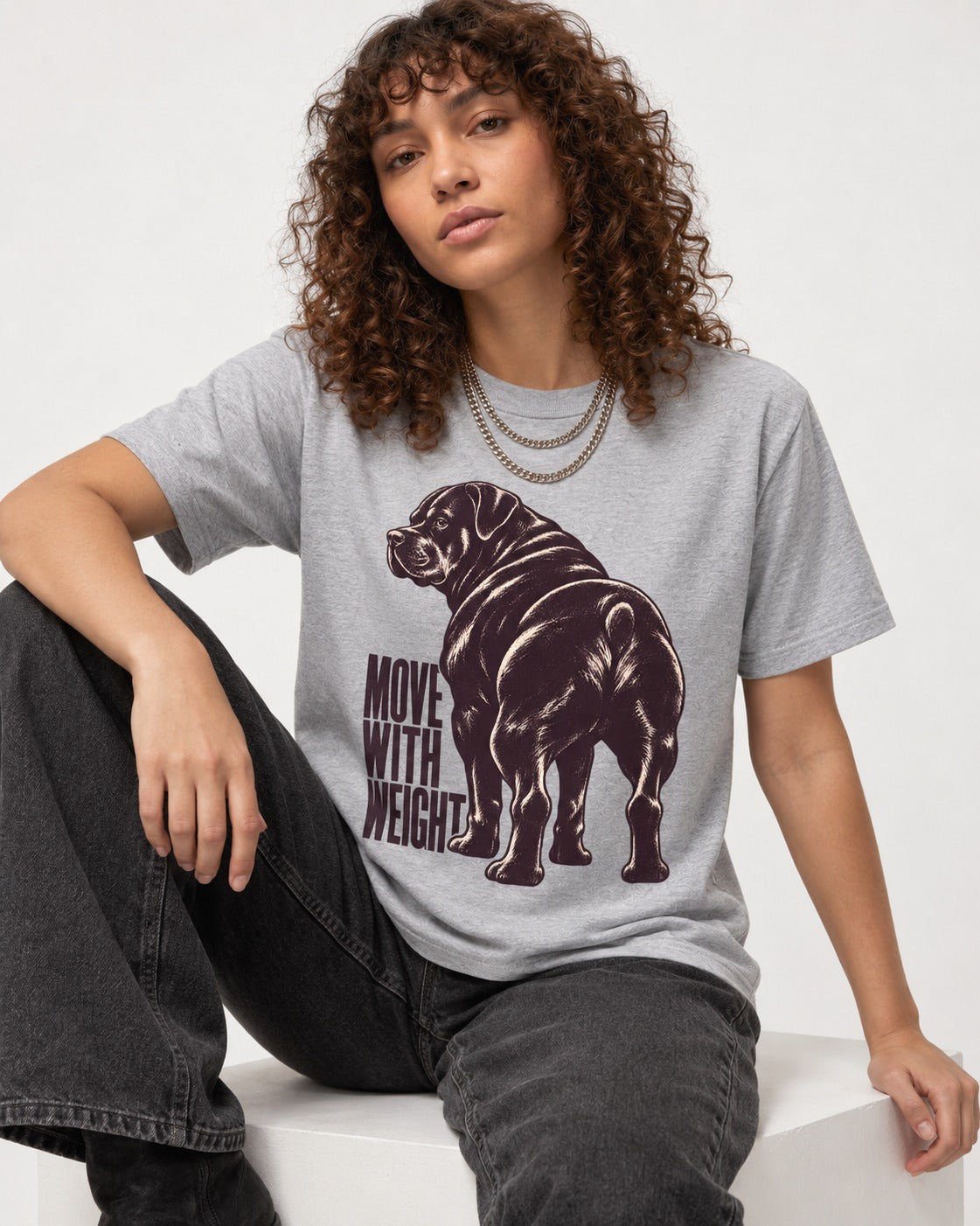 Rottweiler Moves with Weight T-Shirt in Sport Grey, worn by a seated model