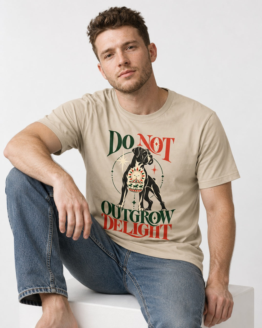 Boxer Do Not Outgrow Delight T-Shirt in Sand, worn by a seated model