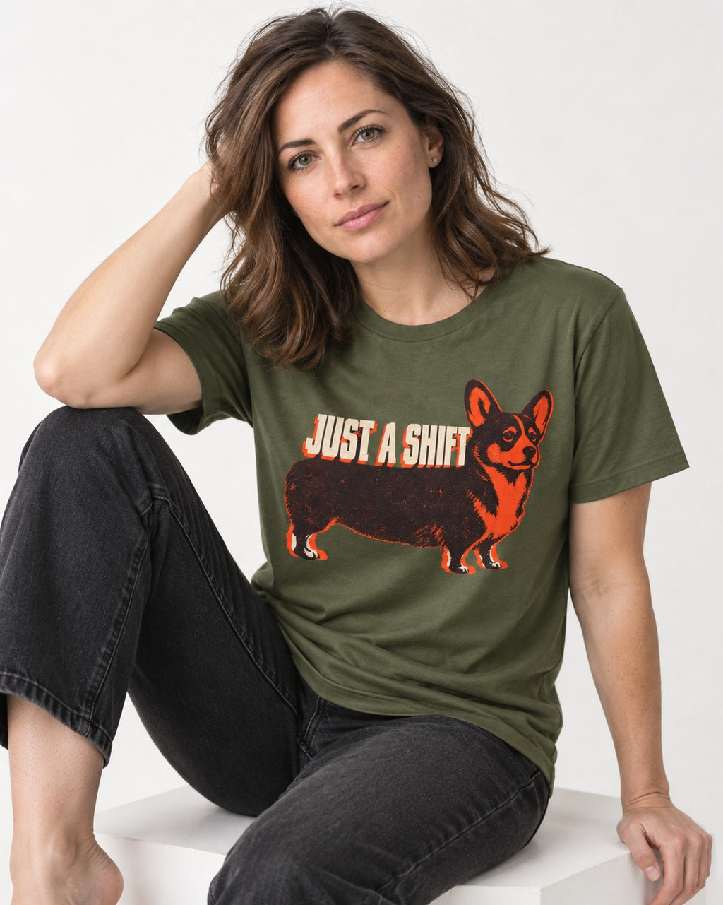 Corgi Just a Shift Typographic Graphic T-Shirt in Heather Military Green, worn by a seated model