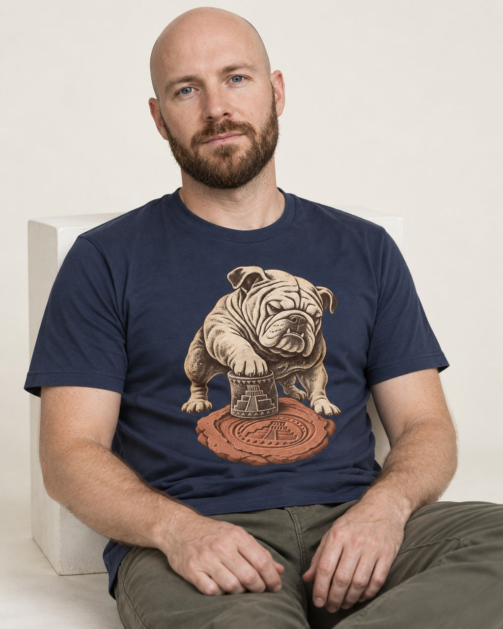 English Bulldog Ancient Cylinder Seal Graphic T-Shirt in Navy, worn by a seated model