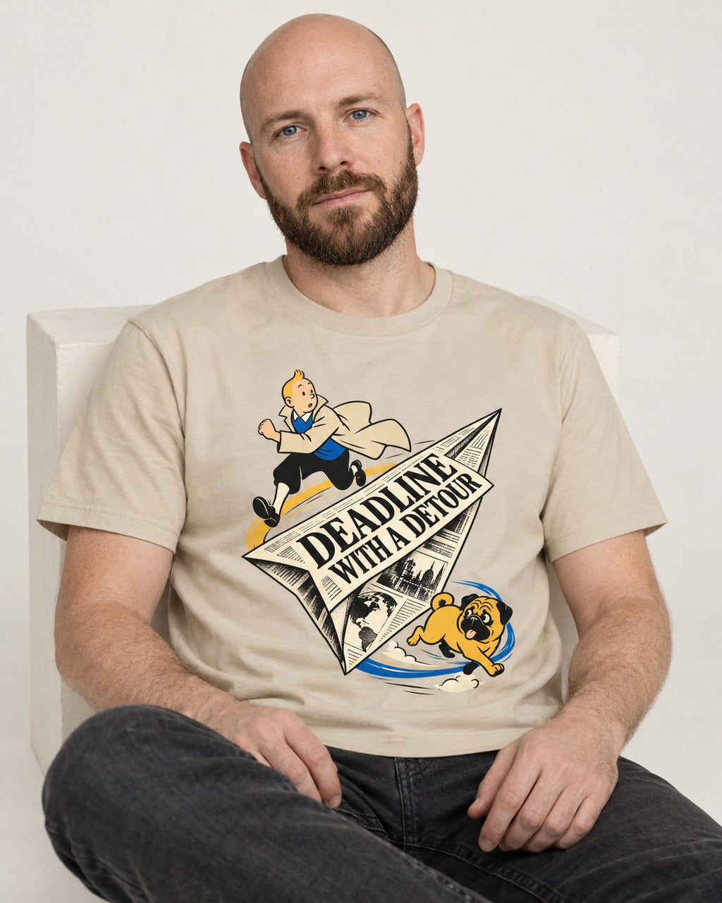 Deadline with a Pug Detour T-Shirt in Sand, worn by a seated model