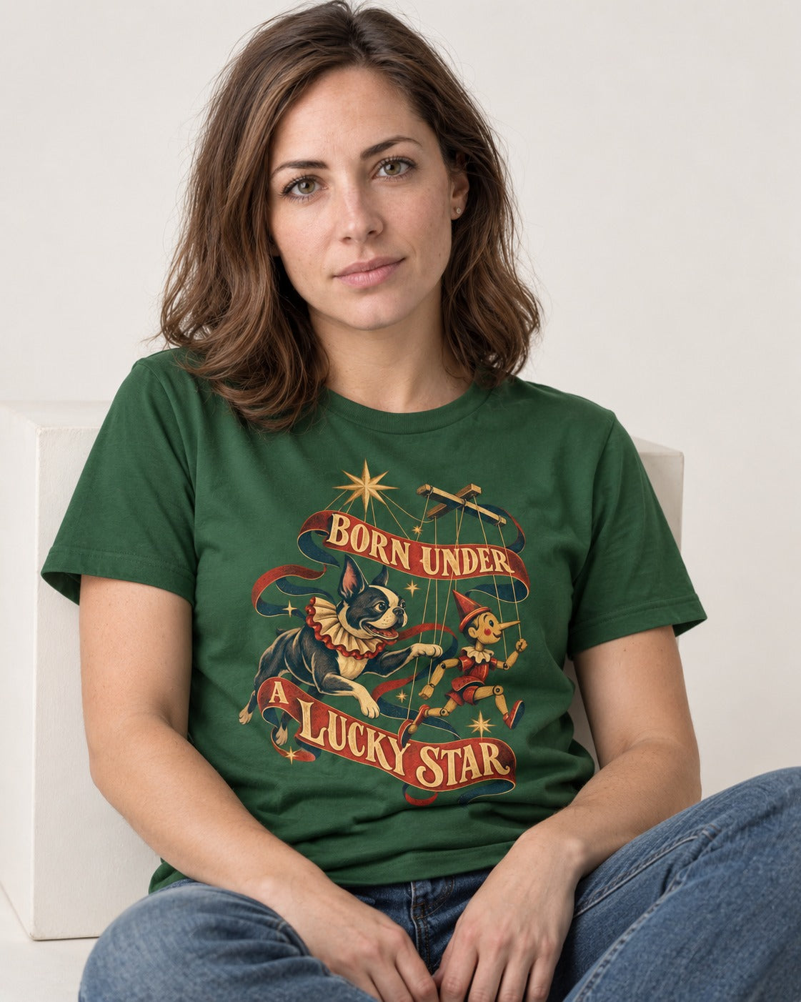 Born Under a Lucky Star Boston Terrier T-Shirt in Forest Green, worn by a seated model