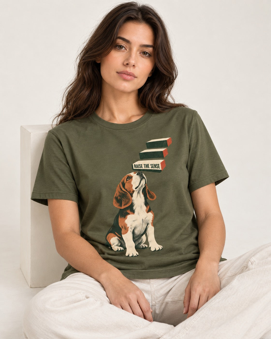 Raise The Sense Beagle Scent Hound T-Shirt in Heather Military Green, worn by a seated model