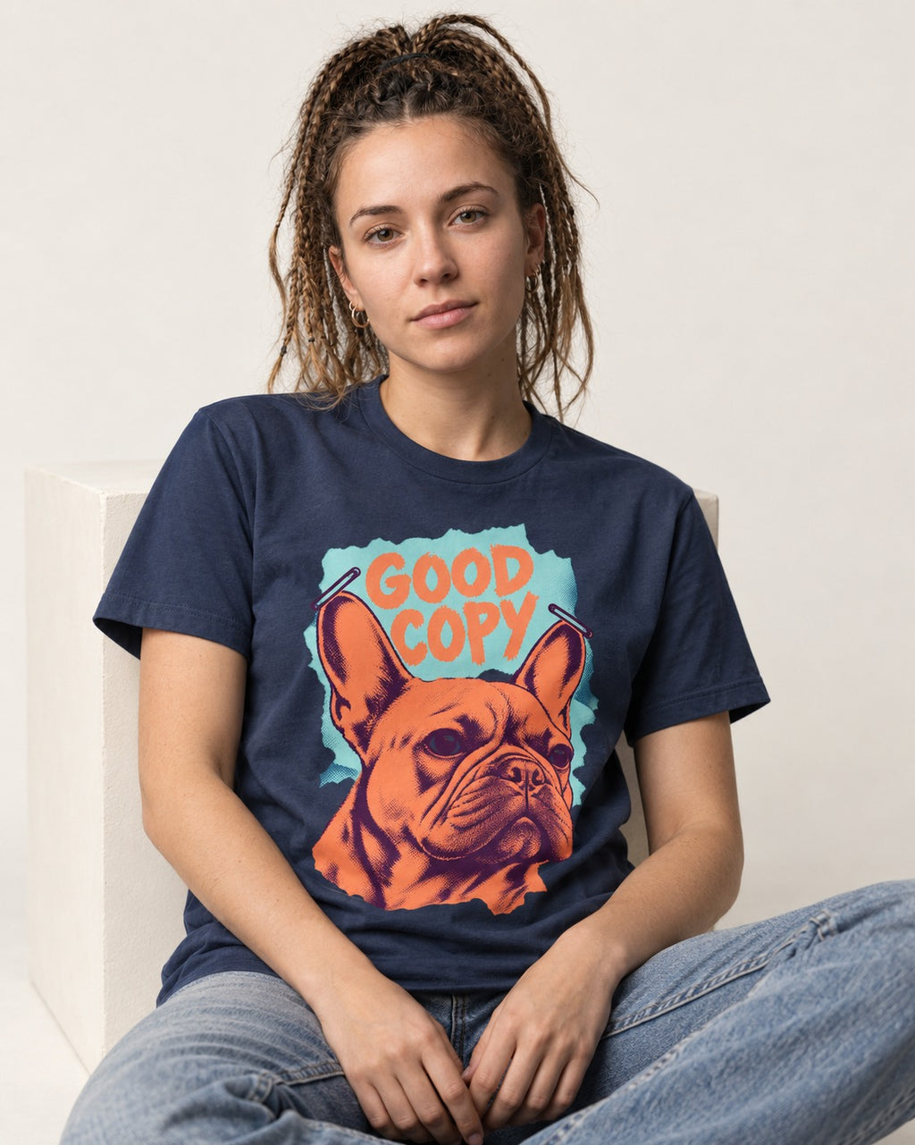 Frenchie Good Copy Stapled Zine Graphic T-Shirt in Navy, worn by a seated model