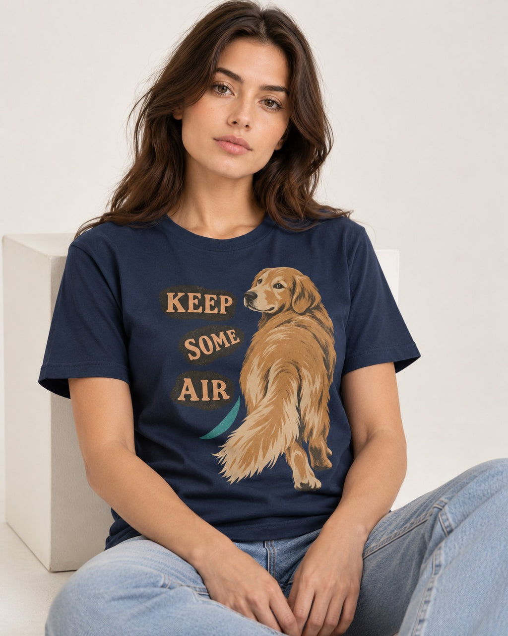 Golden Retriever Keep Some Air Looking Back Graphic T-Shirt in Navy, worn by a seated model