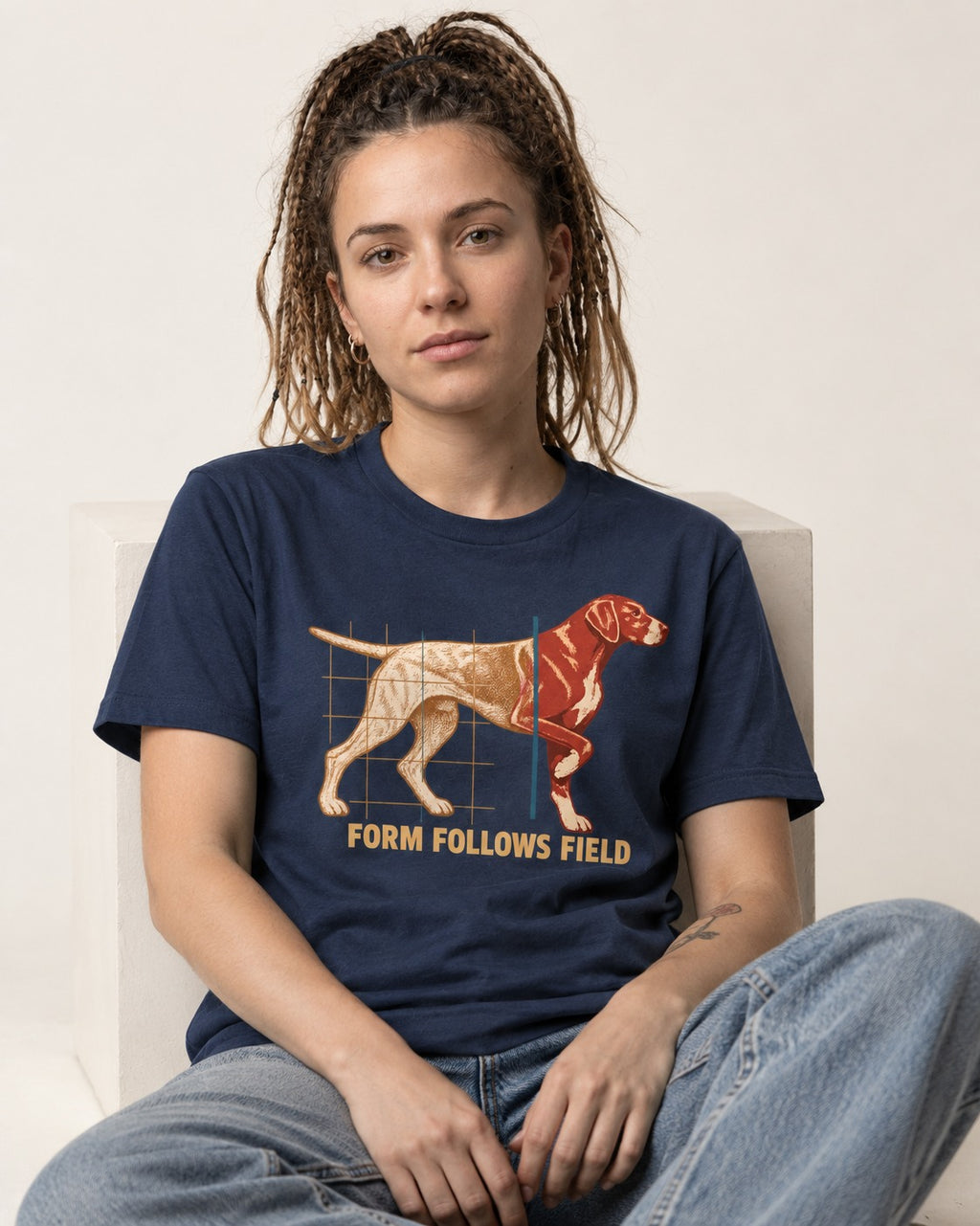 German Shorthaired Pointer Form Follows Field Grid Graphic T-Shirt in Navy, worn by a seated model
