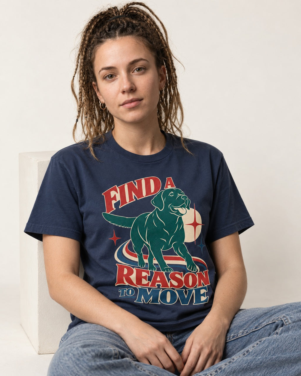Labrador Retriever Find a Reason to Move Retro Dog Graphic T-Shirt in Navy, worn by a seated model