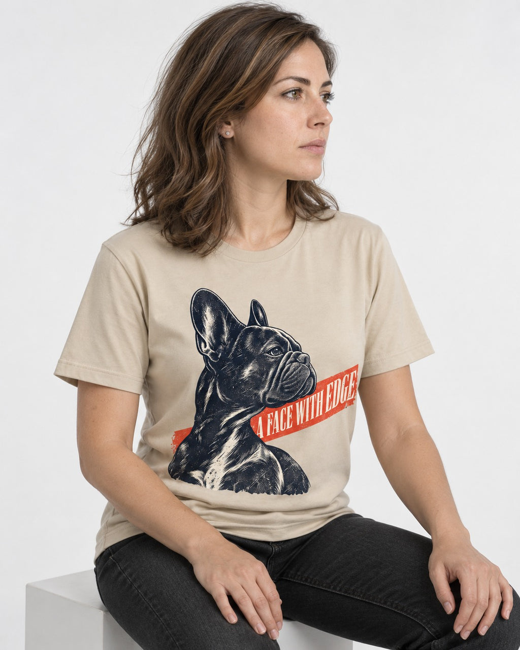 Frenchie Face with Edge T-Shirt in Sand, worn by a seated model