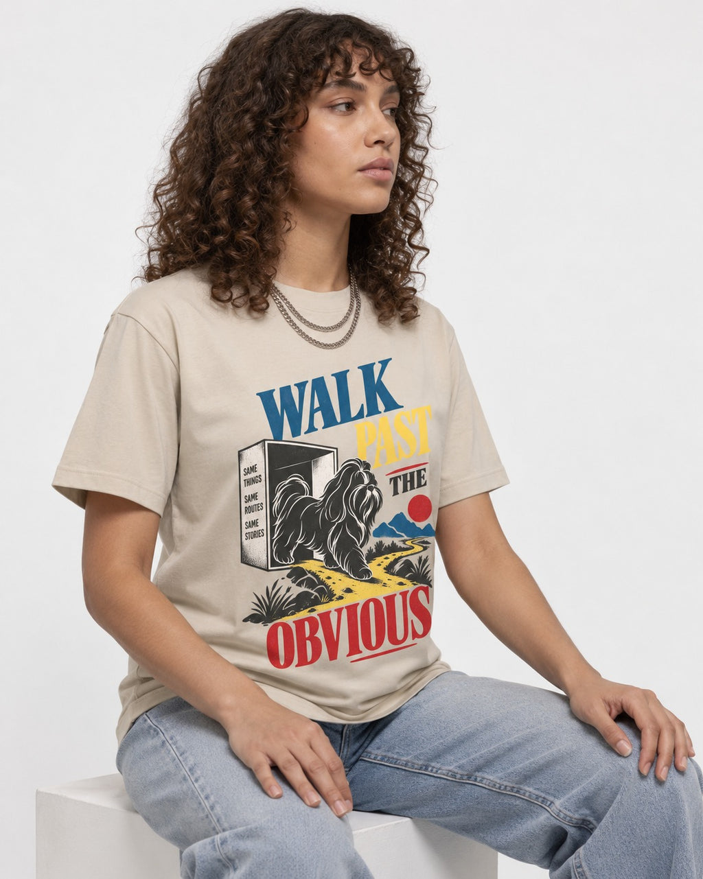 Shih Tzu Walk Past the Obvious T-Shirt in Sand, worn by a seated model