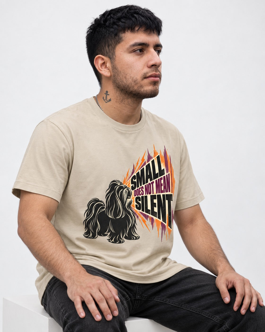 Small Not Silent Shih Tzu T-Shirt in Sand, worn by a seated model