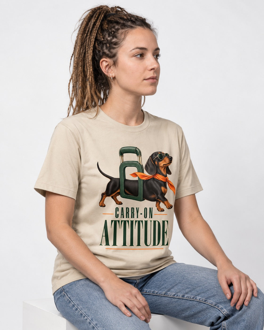 Dachshund Carry on Attitude T-Shirt in Sand, worn by a seated model