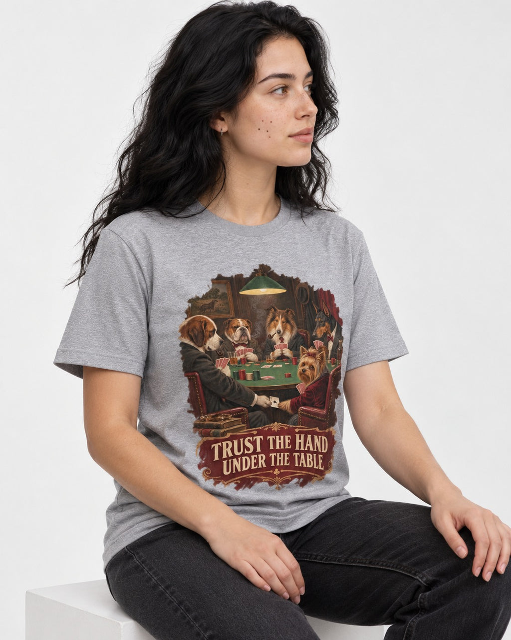 Yorkshire Terrier Trust the Hand Under the Table Poker Dogs Graphic T-Shirt in Sport Grey, worn by a seated model