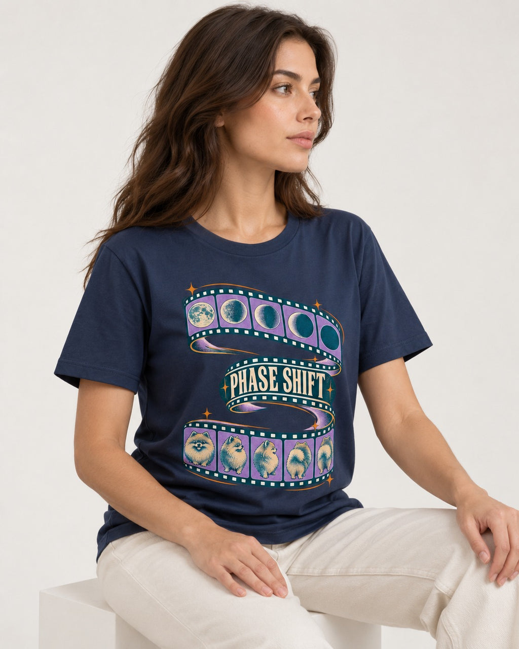 Pomeranian Phase Shift Filmstrip Graphic T-Shirt in Navy, worn by a seated model
