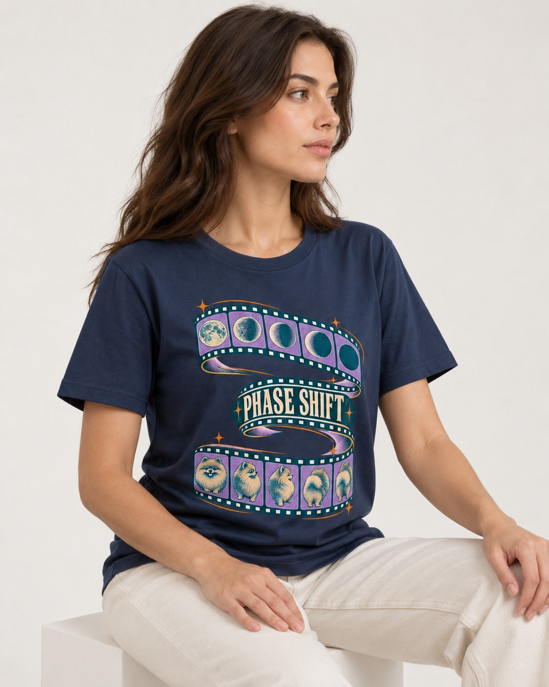 Pomeranian Phase Shift Filmstrip Graphic T-Shirt in Navy, worn by a seated model